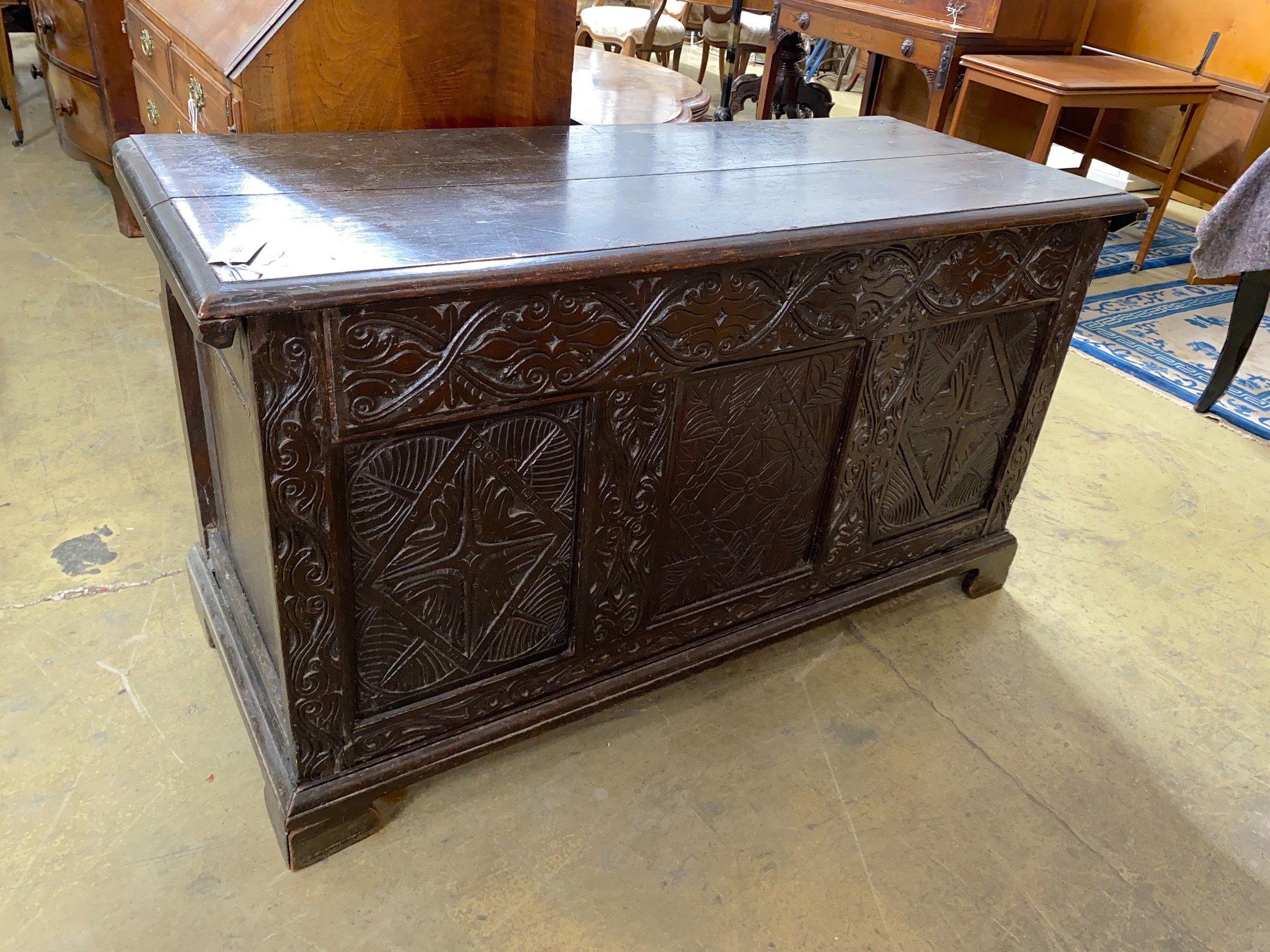 An 18th century and later carved oak coffer, with zinc liner, width 136cm, depth 56cm, height 76cm